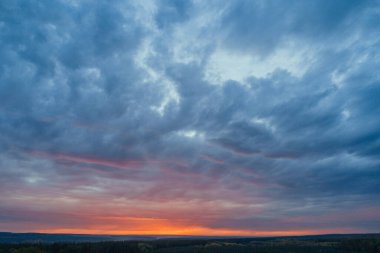 Evening horizon. Sun sitting down at field. Aerial shot of countryside landscape