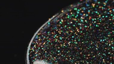 Sıvı büyüsü. Parlak akış sanatı. Şenlik arka planı. Şeffaf ışıldayan sıvı boya akıntısı ve siyah üzerinde makro ateş içinde yüzen rengarenk renkler..