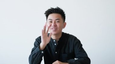 Çevrimiçi toplantı. İş koçluğu. Web sunumu. Başarılı erkek lider el sallayarak beyaz fotokopi arkaplanından selam veriyor. Uzun video çekimi.