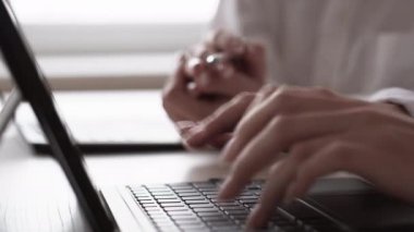 Profesyonel danışmanlık. İş eğitimi. Şirket koçluğu. İş yerindeki laptopta yazı yazan akıl hocasıyla çalışan tanınmayan bir kadın..