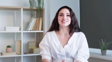 Çevrimiçi pazarlık. Telsiz toplantısı. Uzaktan yönetim. Kendine güvenen bir iş kadını ev ofisinde iş hakkında konuşuyor. Uzun video çekimi.