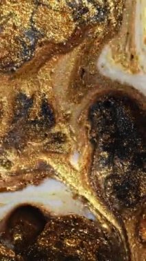 Vertical video. Glitter liquid. Ink mix. Marble texture. Shimmering gold black white color paint blend motion abstract background.
