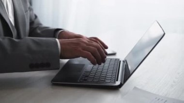 Business online. Digital marketing. Remote job. Virtual communication. Unrecognizable senior male employee hands working typing on laptop at light workplace.