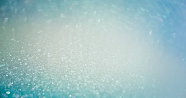 Light flare overlay. Bokeh glow. Glamour sequin gleam. Defocused blue color shimmering sparkles reflection abstract empty space background.