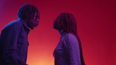 Problem relationship. Couple quarrel. Neon light portrait. Angry black woman and man screaming each other posing blue red background copy space.