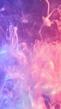 Vertical video. Ink shot. Fluid splash. Haze texture. Pink purple neon color light shiny glitter paint explosion mist cloud abstract background.