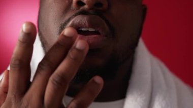 Lip care. Cold sore. Skin hygiene. Dermatology treatment. Cropped closeup of man applying face ointment cream with fingers on red.