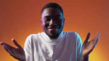 WOW surprise OMG reaction. Great news. Astonished impressed amazed excited happy smiling guy face on orange copy space background.