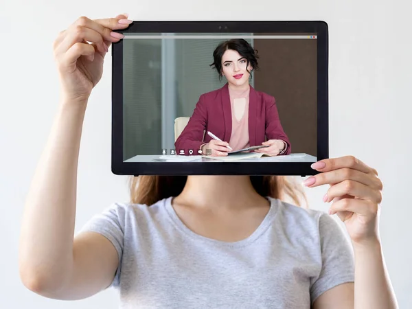 Video meeting. Business coaching. Distant conference. Woman showing confident female expert online on tablet screen on neutral white.