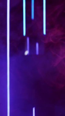 Vertical video. Color smoke. Blur glow. Fluorescent flare. Defocused neon purple blue light vapor floating on dark abstract free space background.