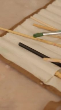Vertical video. Painting workplace. Art tools kit. Creative hobby. Acrylic watercolor paint palette still life picture paintbrush organizer.