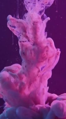 Vertical video. Ink drop. Paint water. Color smoke cloud. Pink purple glowing fluid splash motion on dark neon abstract background.