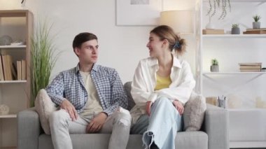 Pleasant meeting. Happy couple. Double date. Excited man and woman coming to friends home to spend time together in light room interior.