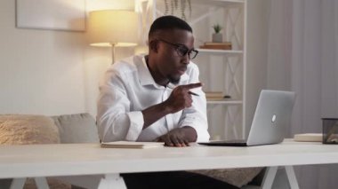 Online conference. Coach webinar. Freelance work. Elegant man teaching online at laptop by video call at home workplace.