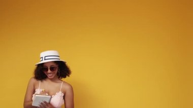 Vacation inspiration. Happy woman. Journey planning. Pretty smiling man and woman making notes in copybook posing on yellow background copy space.