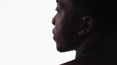 Sad man face silhouette. Loneliness depression. Back view closeup portrait of pensive thoughtful guy isolated on white empty space background.