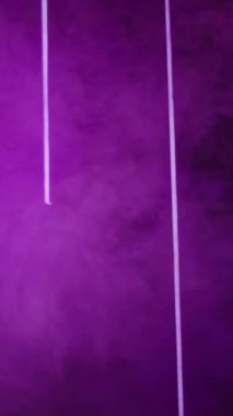 Vertical video. Color vapor. Blur neon light. Ultraviolet illumination. Defocused purple lines glow smoke flow on abstract free space presentation background.