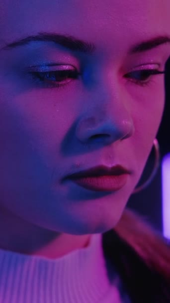 悲しい女だ 失望の後悔 ネオンの肖像画 かなりの女性の気分を害する紫色のライト 垂直ビデオ — ストック動画