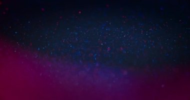 Glitter texture. Neon bokeh light. Sparkling bubbles. Defocused blue magenta pink color glowing circles lens flare on dark abstract background for intro. Shot on RED Cinema camera.