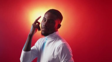 Think gesture. Smart idea. Memorize information. Confident cheerful guy finger tapping head temple on red orange color gradient copy space background.