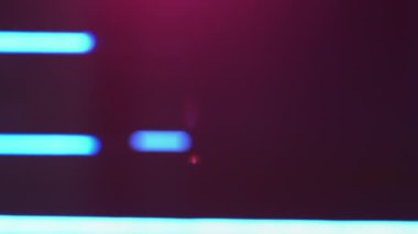Light leak. Defocused neon glow. Fluorescent illumination. Blur purple blue color lens flare beam on dark abstract free space background.