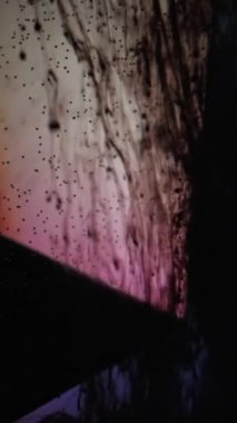 Vertical video. Ink drop. Paint water. Smoke flow. Black fluid drip motion bubbles on glass cube edge on blue pink dark grunge abstract background.