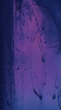 Vertical video. Ink water. Paint drop. Fume flow. Blue pink color ink splash mix floating motion on dark neon abstract background.