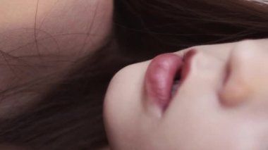 Vertical people. Feminine nature. Sensual woman. Tender beauty. Unrecognizable brunette lady with ruby lips posing in wind blow blur slow motion.