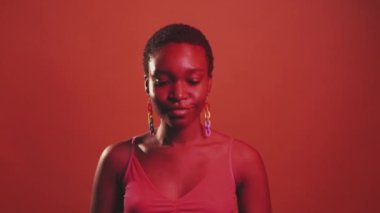 Heart gesture. Love care. Affection admiration. Red neon color light playful flirting woman showing romantic signal isolated on dark bright copy space background.