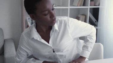 Business woman lifestyle. Wfh professional career. Working from home. Confident female leader beginning corporate day using laptop at white workplace in light modern office interior.