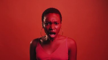 Shocked face. Fear anxiety. Wtf expression. Red neon color light perplexed overwhelmed scared woman with open mouth isolated on dark bright gif loop boomerang animation.