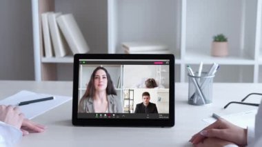 Online interview. Web meeting. Internet negotiation. Business team celebrating successful cooperation with applause on tablet at virtual office.