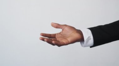 Gender equality. Diverse partnership. Employee support. Unrecognizable multicultural man woman colleagues holding hand on light background.
