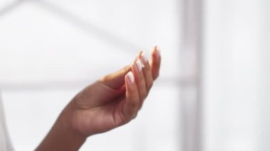 Hand care. Skin nourishing. Cosmetic dermatology. Unrecognizable woman rubbing fingers applying smearing cream on white free space background.