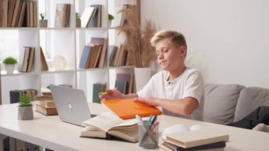 Exhausted education. Tired schoolboy. Finish tasks. Casual teenager boy getting in order educational stuff taking nap on sofa light room interior.