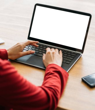 Office work. Computer mockup. Network search. Female hands working laptop blank screen sitting desk light room interior.