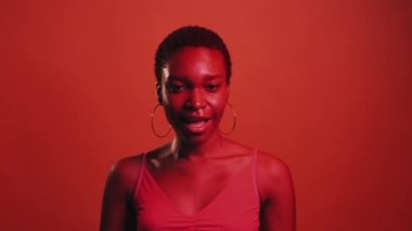 Perfect gesture. Yes okay. Super cool. Approving agreement. Red neon color light pleased woman winking accepting with ok sign isolated on dark bright gif loop boomerang animation.