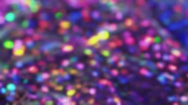 Blue lights background. Defocused shimmer. Festive colorful blinking illumination with glitter tinsels surface bokeh macro shooting.