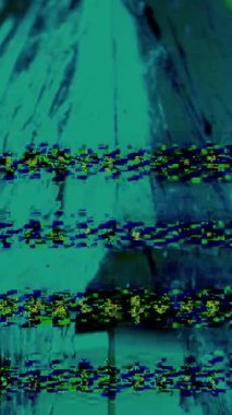 Vertical video. Glitch art. Pixel interference. Signal error. Green cyan blue color grain static noise texture on fluid splash on glass pyramid abstract background.