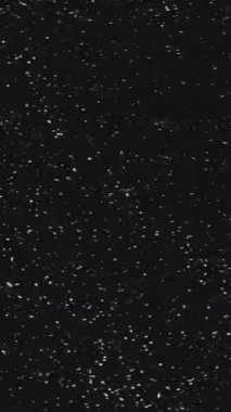 Vertical video. TV glitch grain noise. Signal interference. Black white real analog old VHS static distortion texture dark retro effect overlay.