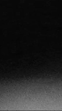 Vertical video. Retro film glitch noise. Old TV interference. Dark black white real analog static grain texture distortion flicker transition overlay effect.