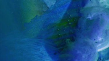 Vertical video. Fluid splash. Paint water. Explosion fume. Blue green color ink flow smoke cloud motion over glass cube angle abstract background.