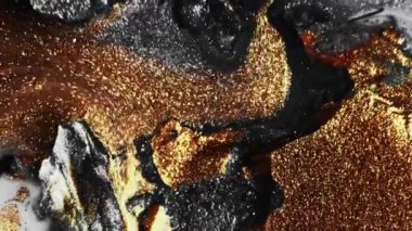 Köpüklü sıvı. Boya karışımı. Sıvı dökülmesi. Odaklanmamış parlak altın bronz gümüş rengi parlak mürekkep hareketi soyut arkaplan.