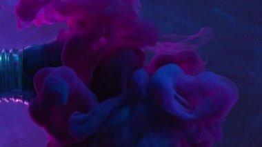 Vertical video. Color fume. Paint splash. Pink blue smoke cloud explosion motion in broken light bulb in water on dark abstract background.
