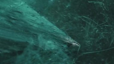 Vertical video. Paint splash. Mist cloud. Mountain hill. Green color ink fluid drop motion on ice cube angle in water on dark abstract background.