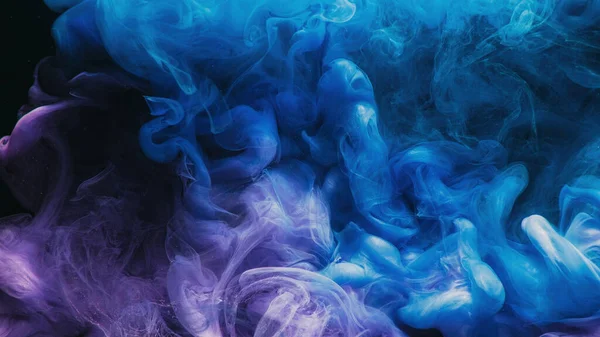 Color smoke. Paint splash. Ink water mix. Explosion fume. Blue purple glowing glossy vapor texture on black abstract art background with free space.