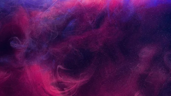 Glitter mist. Color vapor texture. Ink water mix. Fantasy sky. Neon pink blue shiny sparkling particles smoke floating on dark abstract art background with free space.
