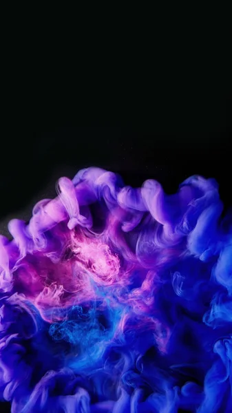 Paint splash. Ink water. Fluid burst. Magic spell. Vibrant pink blue purple color vapor cloud on dark black abstract art copy space background.