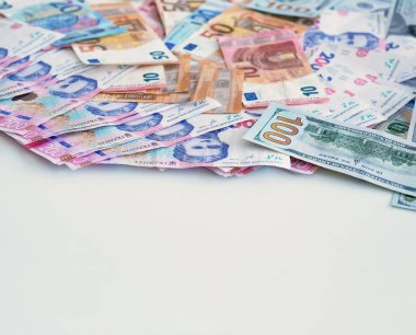 Para yığını. Dünya ekonomisi. Küresel pazar Renkli Avro Amerikan Doları Ukrayna UAH Hryvnia Kâğıdı, beyaz boş alan arka planına para yatırıyor.