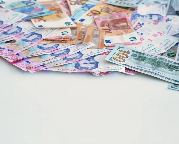 stock image Money pile. World economy. Global market. Closeup of colorful Euro US American dollar Ukrainian UAH hryvnia bill paper banknotes cash on white empty space background.